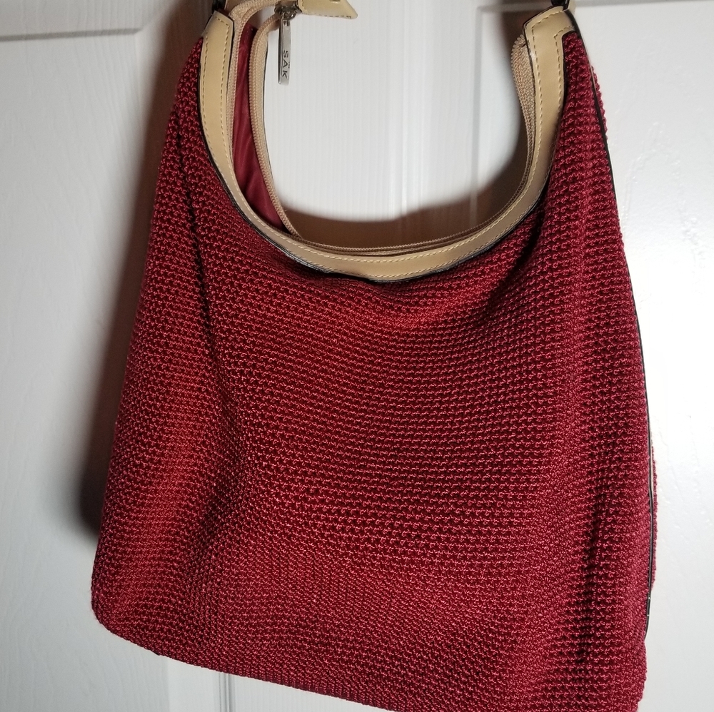 Red, clean, lightly used, The Sak brand shoulder bag w/ genuine leather trim